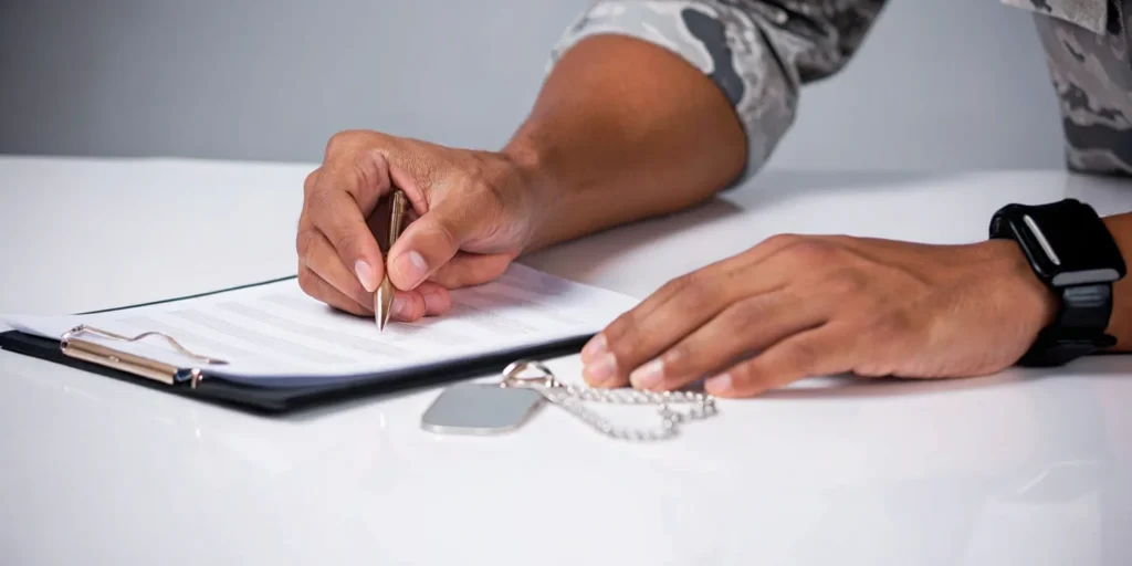 A veteran reviews paperwork to decide what to do after a VA claim is denied.