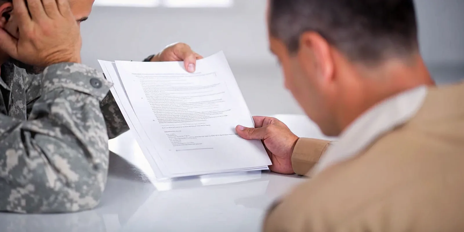 Veteran reviewing why VA tinnitus claims get denied with claim paperwork